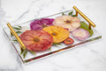 Decorative resin tray with pressed floral design on a marble surface