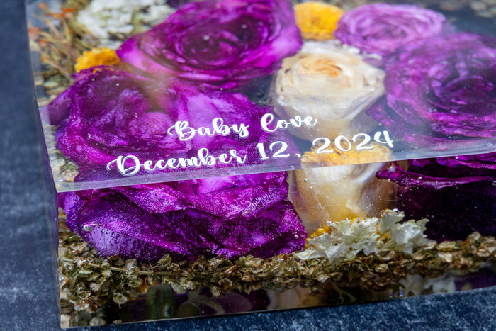 Landscape photo of a pressed flower personalised mantel block with purple flowers and a special date