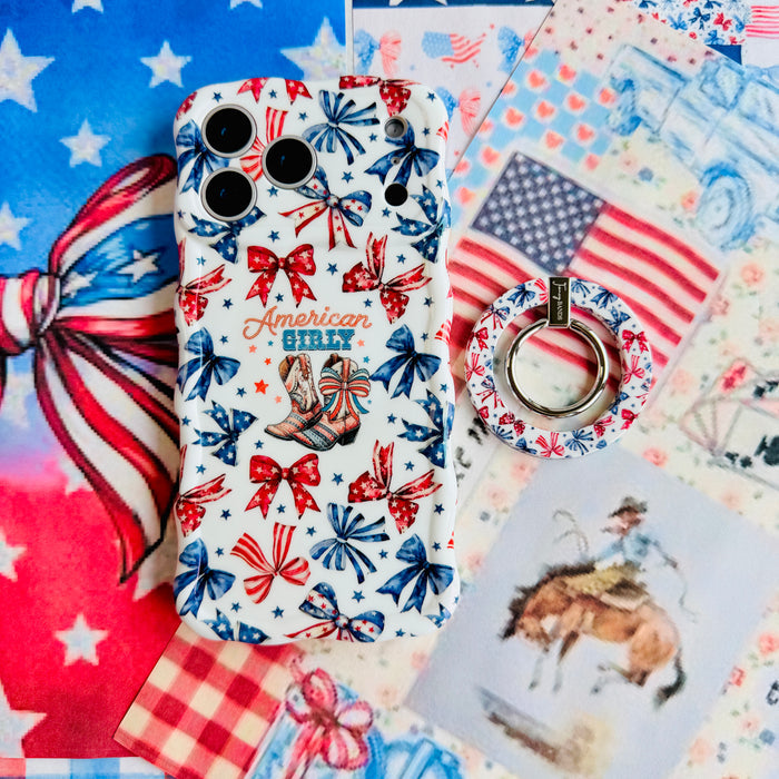 American Girly MagSafe grip ring attached to the matching American Girly iPhone case, styled with an American flag, red gingham and a cowboy illustration.
