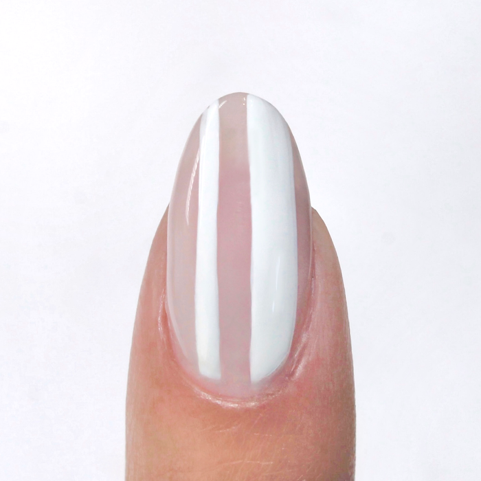Blank Canvas white liner used for white vertical stripes on a sheer nude nail
