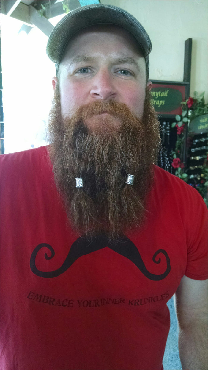 Biker wearing Celtic Strength Hair Bead at motorcycle rally, sterling silver Viking braid jewelry.