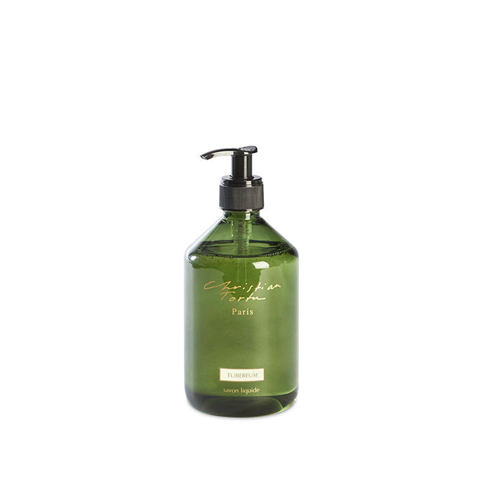 Green bottle with pump dispenser on a white background