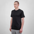Man wearing a black t-shirt and gray pants on a white background
