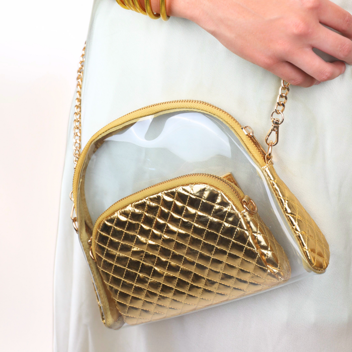 a person wearing a gold purse