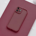 Burgundy Cloud Soft NAKD phone case by Coconut Lane on a matching burgundy surface, light background.