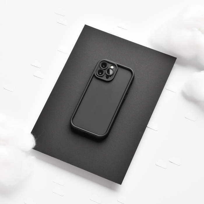 Black smartphone in a Coconut Lane Cloud Soft NAKD Kohl Black case on black background with white clouds.