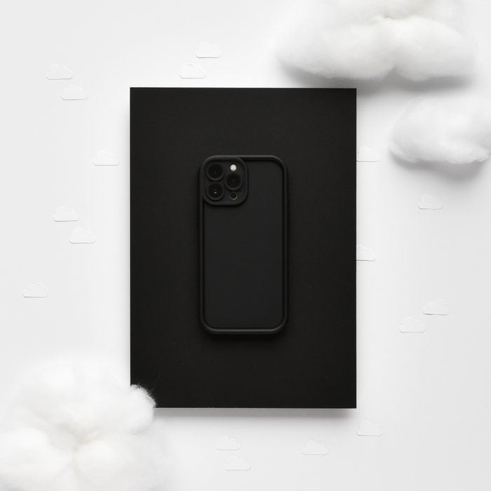 Black iPhone in a matte black cloud-pattern soft case, placed on fluffy white cotton clouds.