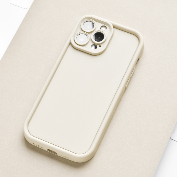 Pebble beige Cloud Soft NAKD phone case by Coconut Lane on a beige smartphone, resting on a light background.