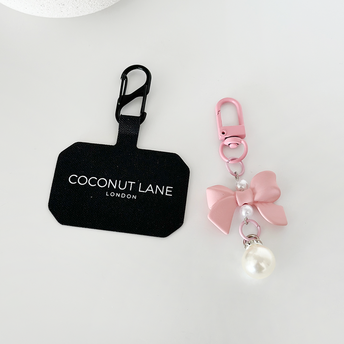 Peach pink Coquette Bow phone keyring bundle with brand tag on a white surface.