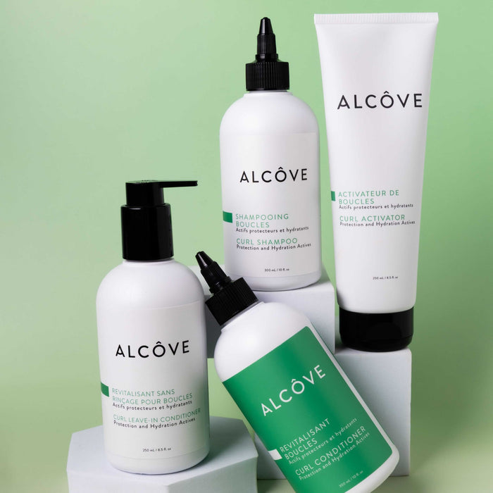 Set of Alcove hair care curl products on a light green background