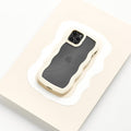 A smartphone encased in the Curvy Phone Case - Cream from Coconut Lane is set against a white and beige abstract background. The phone's rear camera, featuring multiple lenses, is visible, and the Apple logo can faintly be seen through the design on the back of the iPhone 15 case.