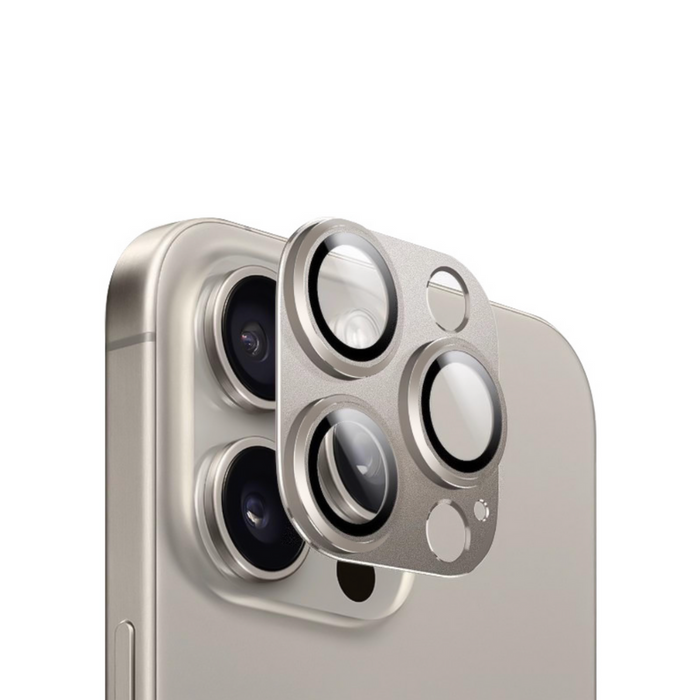 Coconut Lane Full Protection Camera Lens Cover in natural titanium being placed over an iPhone camera, close-up view.