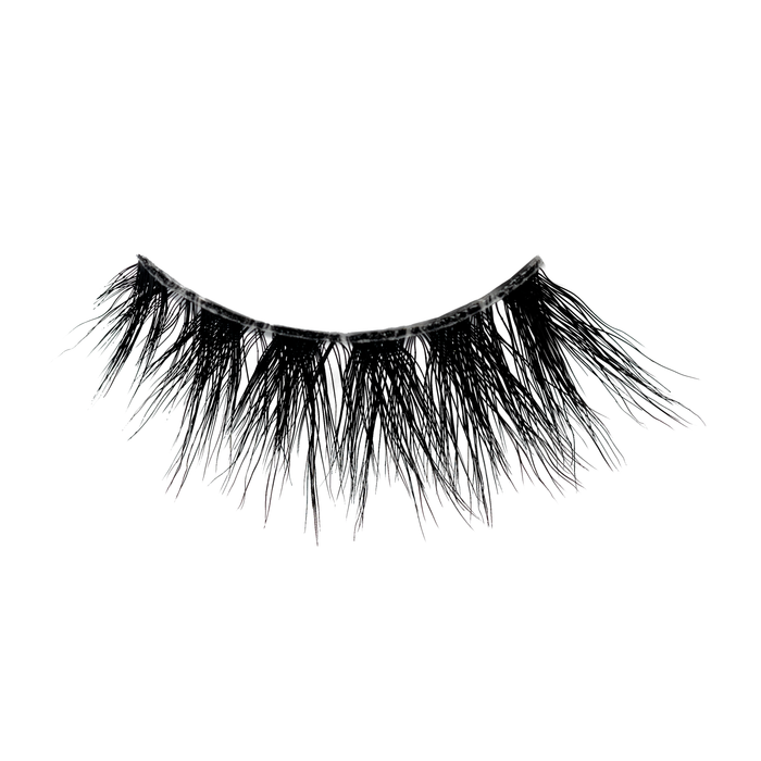 Close-up of a curved black lash fringe resembling false eyelashes against a white background