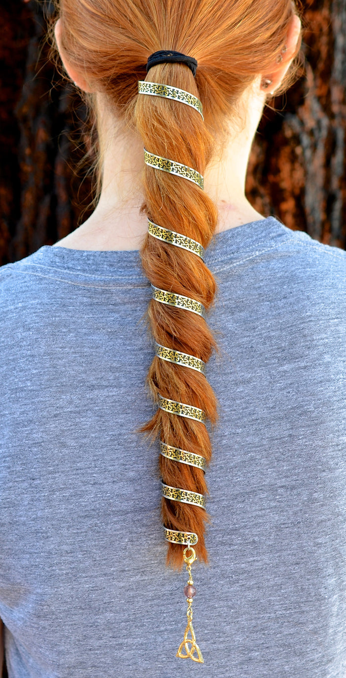 12-inch gold Celtic eternity ponytail wrap spiraled through braided red hair with trinity knot charm, back view