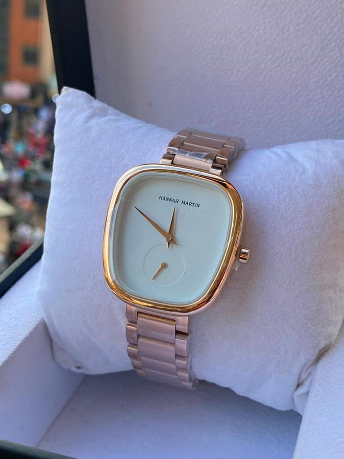 Hannah Martin rose gold cushion-case watch on white display pillow