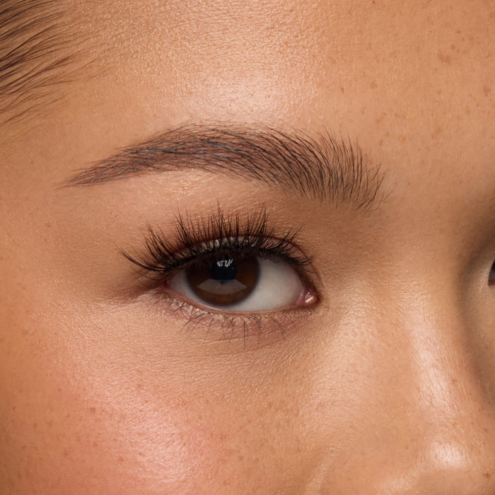 Iconic Lite Demi a long, flared half lash with medium volume and spiky fibers shown on an eye.