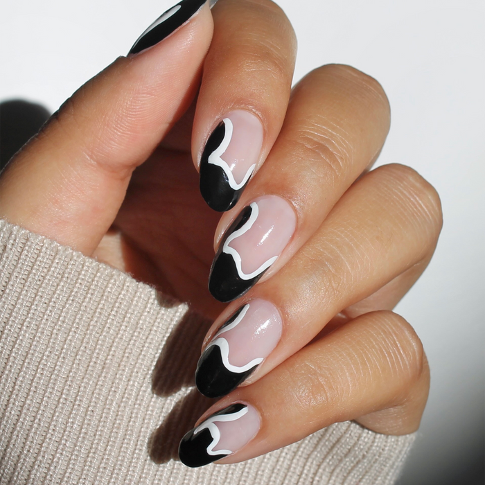 Ink-redible black liner used for black and white swirl nail art on a sheer nude manicure