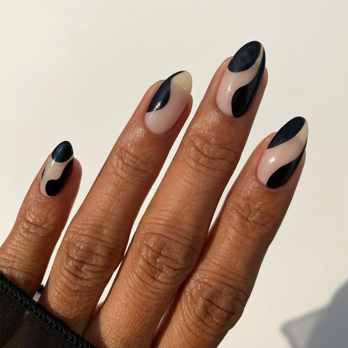 Ink-redible black liner used for abstract black French tip nail art on a light skin tone