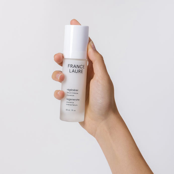 Hand holding France Laure Regenerate Jouvenance Intense Serum, 30ml bottle for youthful skin renewal and radiance