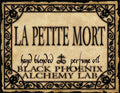 Label for 'La Petite Mort' hand blended perfume oil by Black Phoenix Alchemy Lab with decorative border.