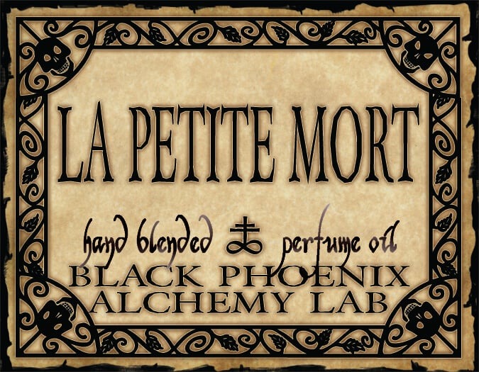 Label for 'La Petite Mort' hand blended perfume oil by Black Phoenix Alchemy Lab with decorative border.
