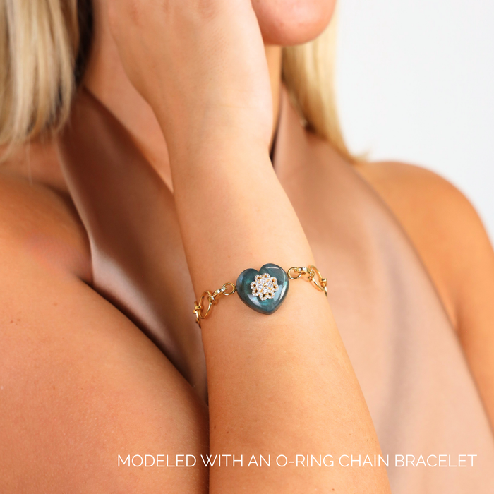 Labradorite Heart Charm showcased on a wrist with an O-ring chain bracelet, highlighting its luminous beauty.