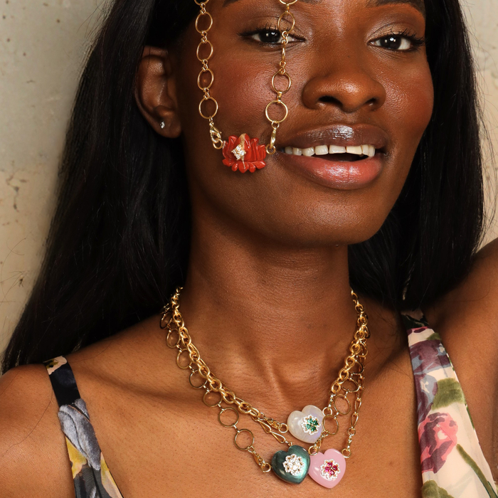 Clear Quartz Heart Charm worn as part of a layered necklace featuring colorful heart-shaped gemstones.