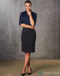 Woman in dark blue blouse and black mid-length pencil skirt showing stylish pencil skirt look