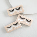 Lite Collection Custom 3-Pack with three peach boxes of lashes displayed on a pale surface.
