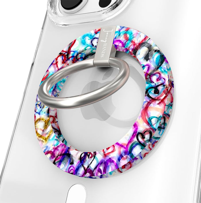 Love Out Loud colorful graffiti heart pattern MagSafe phone grip ring with overlapping neon pink purple and turquoise hearts compatible with iPhone and Samsung