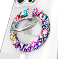 Love Out Loud colorful graffiti heart pattern MagSafe phone grip ring with overlapping neon pink purple and turquoise hearts compatible with iPhone and Samsung
