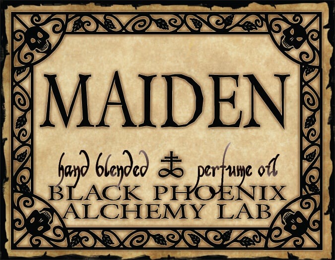 Label for 'MAIDEN' hand blended perfume oil by Black Phoenix Alchemy Lab with decorative border.