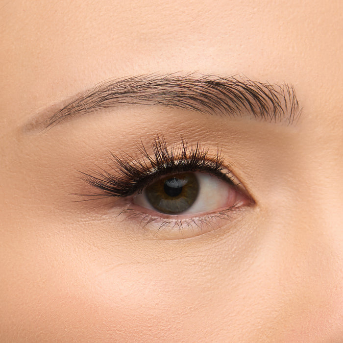 Midnight Demi a dramatically flared half lash with extra-long length, bold volume, and textured spiky clusters creating a 4D effect shown on an eye.