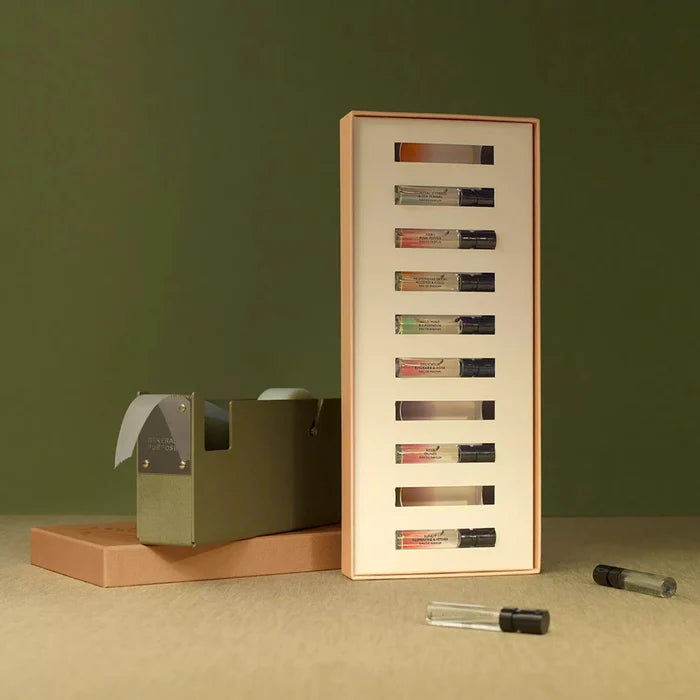 Set of small glass vials in a display case on a green background