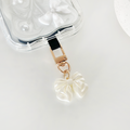 Clear marble phone case with pearlescent bow charm keyring from Coconut Lane.
