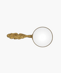 Vintage inspired magnifying glass with a distinct ornate handle shaped like a textured gold leaf or feather. The glass lens is clear, creating an elegant, antique feel. | SW Home