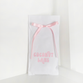 Coconut Lane phone case gift pouch with pink lettering and ribbon on a simple, eco-friendly fabric.