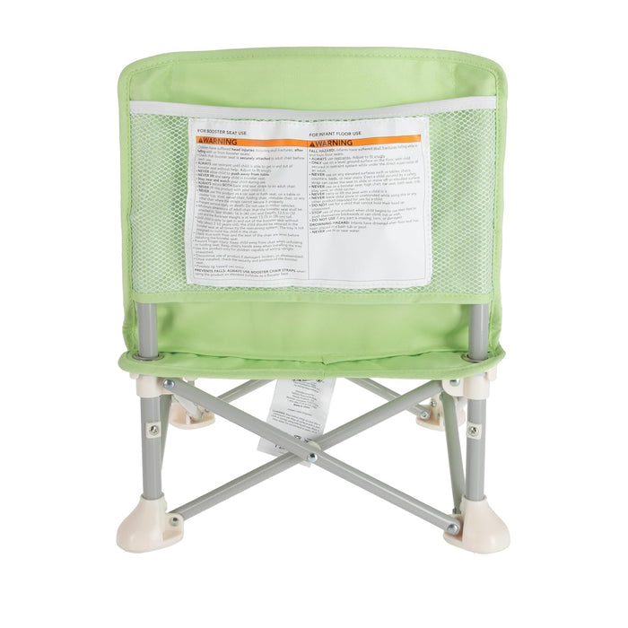 The Nuby Pop Up Booster Seat | Green is shown from the back, displaying a mesh pocket with a white warning label and gray metal legs with white plastic feet.