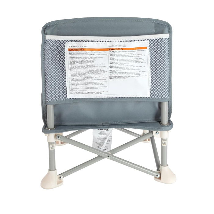 The Nuby Pop Up Booster Seat in grey features a mesh-backrest, safety warning labels, and sturdy metal legs with white plastic feet—perfect as a portable baby seat—shown from the back.