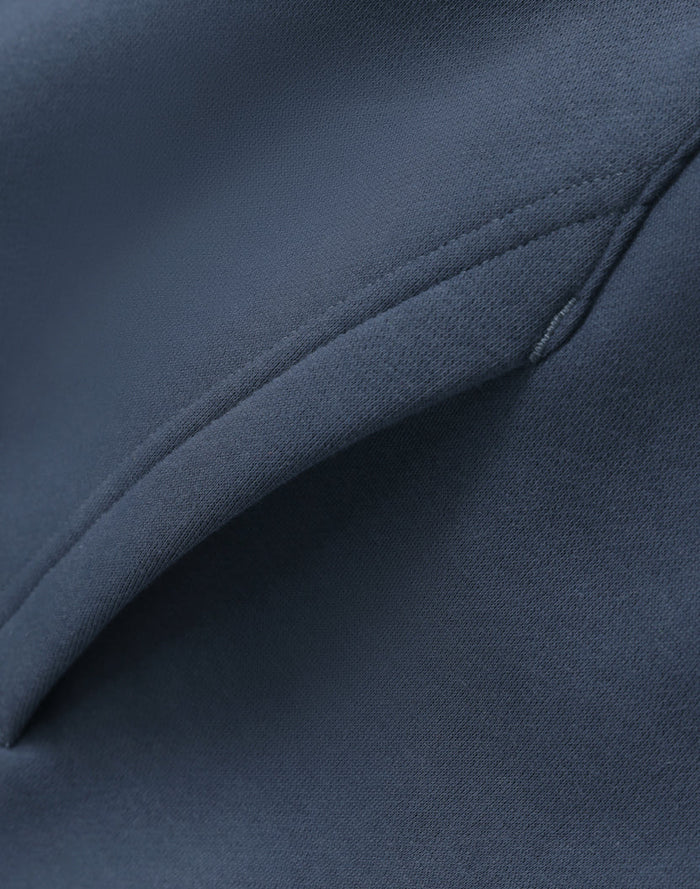 Dark blue premium oversized slate hoodie with smooth textured fabric and stitched seams perfect for work uniforms