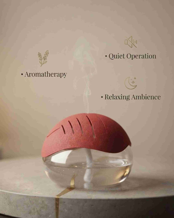 Red aroma diffuser with clear dome-style base on tabletop