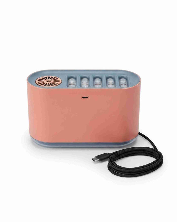 Pink aroma diffuser with fountain-style top vent, gray base, and black power cord