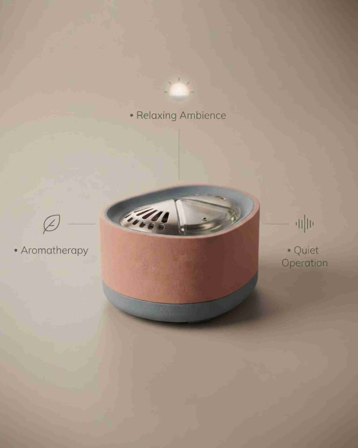 Pink aroma diffuser on flat surface with top vent and LED light