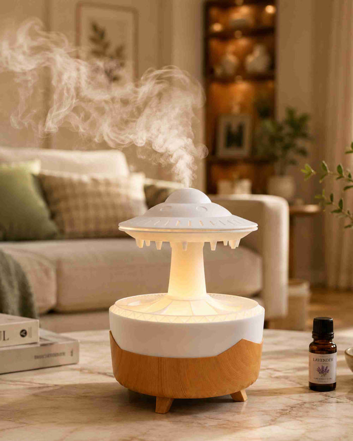 Rainfall aroma diffuser with lit interior and mist plume in a living room