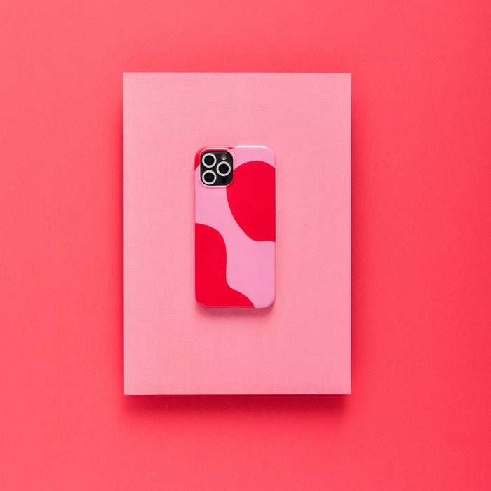 Coconut Lane smartphone with silver glitter camera lens covers on a pink rectangle, set against a red background.