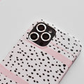 White Coconut Lane iPhone case with black dots, pink stripes, and silver camera lens covers.
