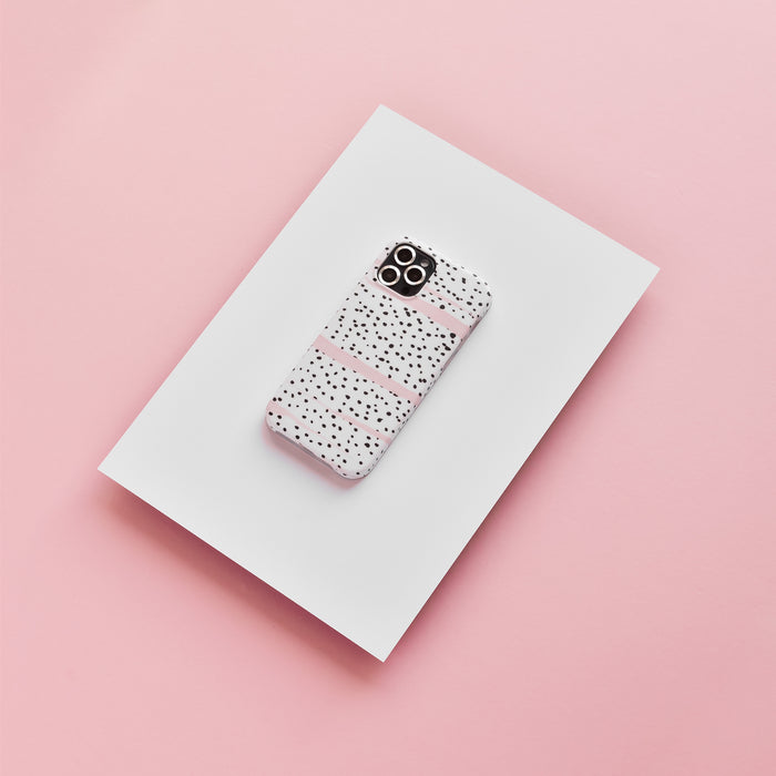 Silver Coconut Lane camera lens covers on iPhone with pink and black dotted case, set against a pastel pink background.
