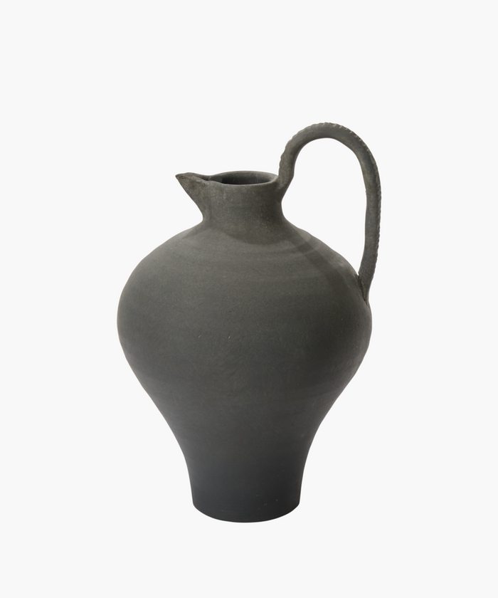A gray pottery jug with a narrow spout, rounded body, and curved handle. The texture appears smooth, conveying an earthy, traditional feel. | Wildwood Home Co.