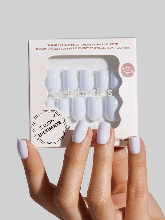 Nail art package with a hand displaying white nails against a light gray background