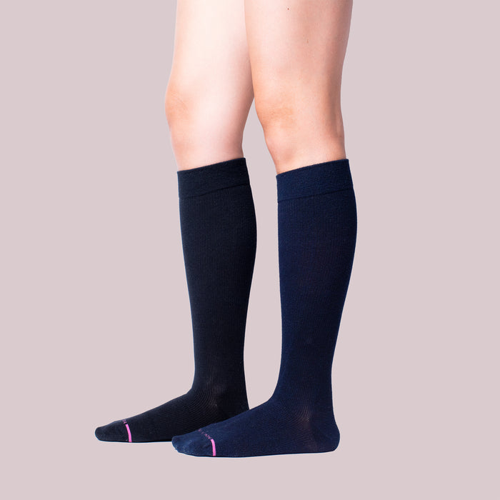 Knee-high compression socks in a solid dark color with contrasting toe detail.